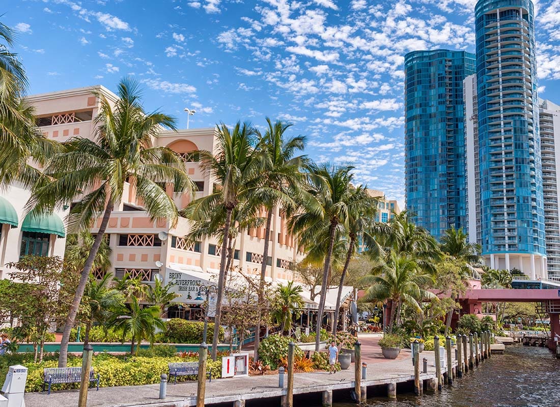 Fort Lauderdale, FL - Palm Trees by the Water Next to Commercial Buildings in Downtown Fort Lauderdale Florida on a Sunny Day